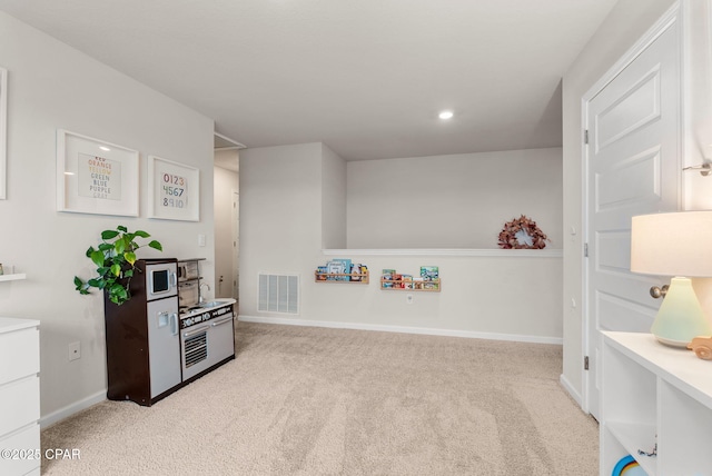 playroom with baseboards, visible vents, and light carpet