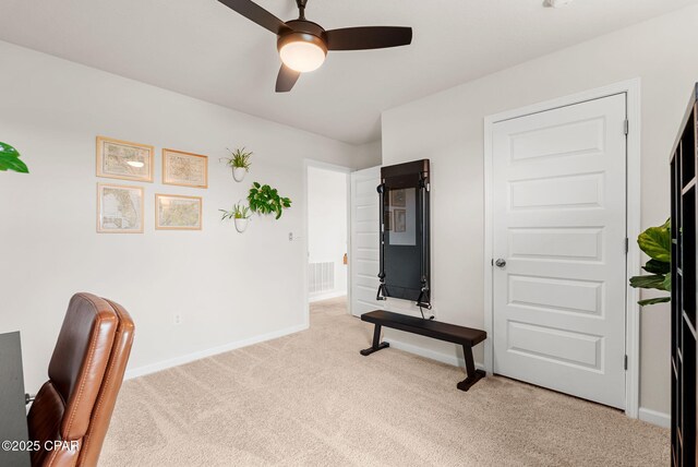 carpeted office space featuring visible vents, a ceiling fan, and baseboards