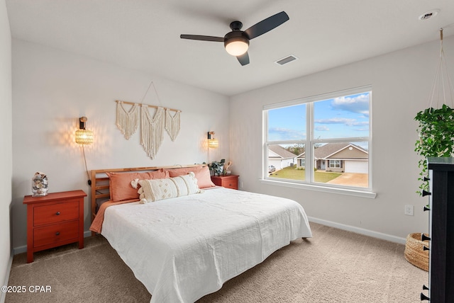 bedroom with carpet flooring, ceiling fan, baseboards, and visible vents