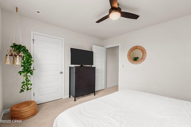 bedroom featuring baseboards, light colored carpet, and ceiling fan