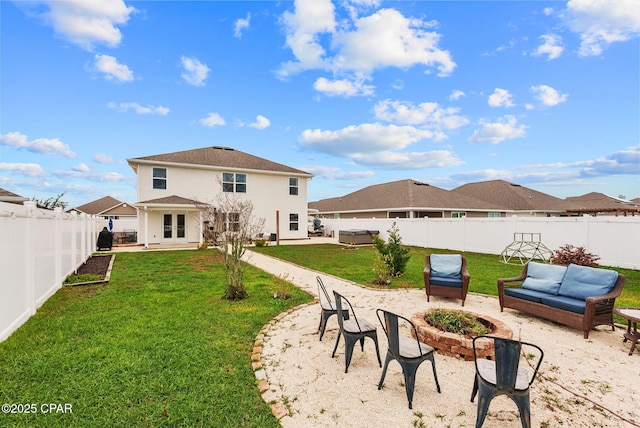 rear view of property featuring a patio area, a lawn, a fenced backyard, and a fire pit