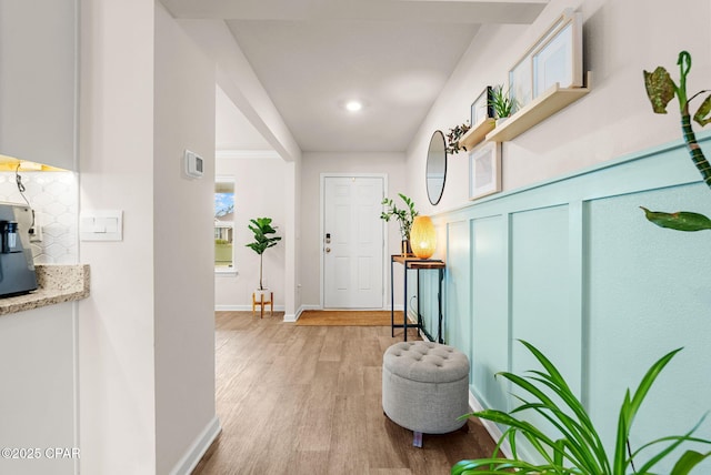 entrance foyer with baseboards and light wood-style floors