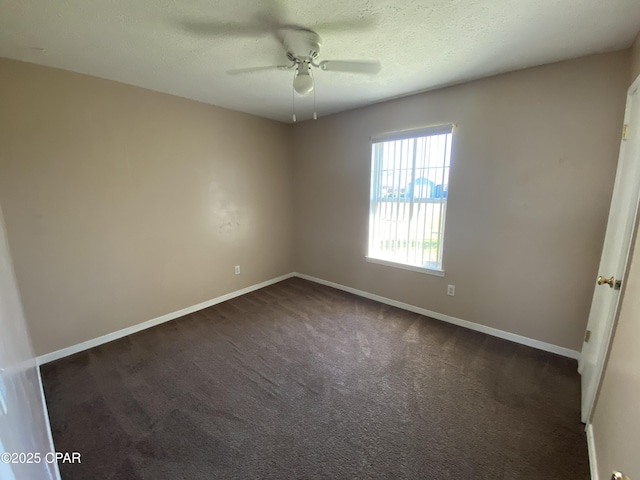 unfurnished bedroom featuring baseboards, a textured ceiling, ceiling fan, and dark carpet