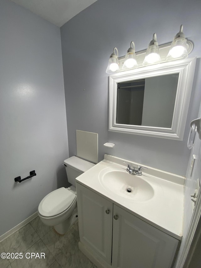 half bath featuring tile patterned flooring, toilet, and vanity