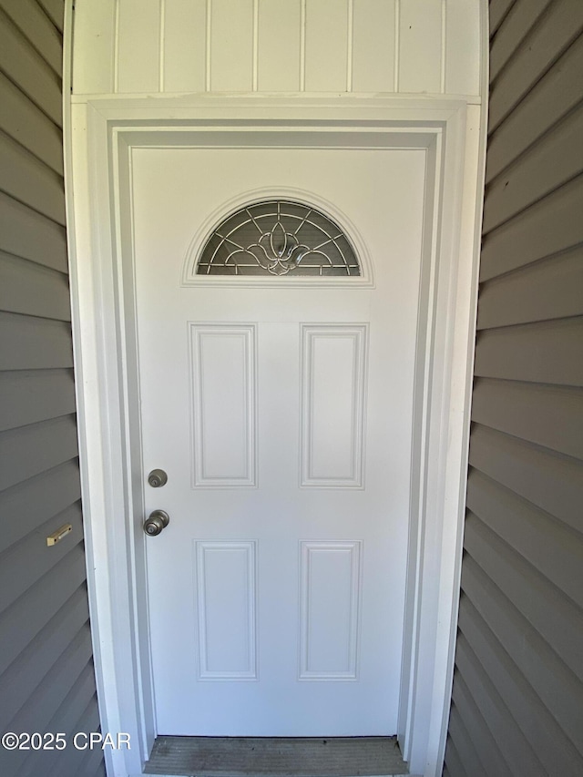 entrance to property featuring board and batten siding