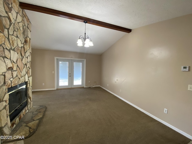 unfurnished living room with a stone fireplace, lofted ceiling with beams, dark carpet, and a textured ceiling