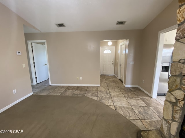 interior space featuring baseboards and visible vents