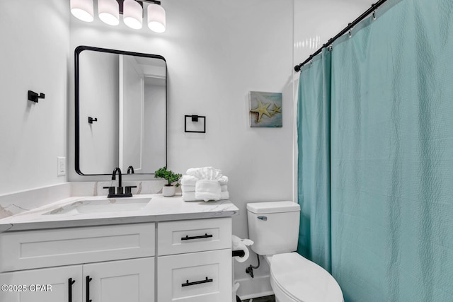 bathroom featuring curtained shower, toilet, and vanity