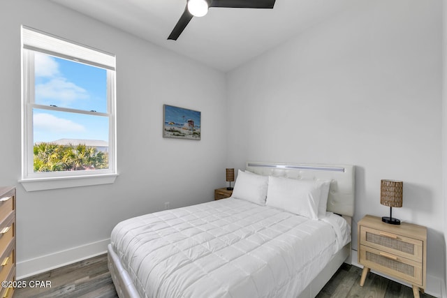 bedroom with ceiling fan, baseboards, and wood finished floors