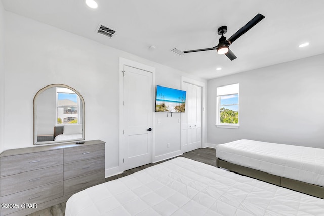 bedroom featuring recessed lighting, visible vents, baseboards, and wood finished floors