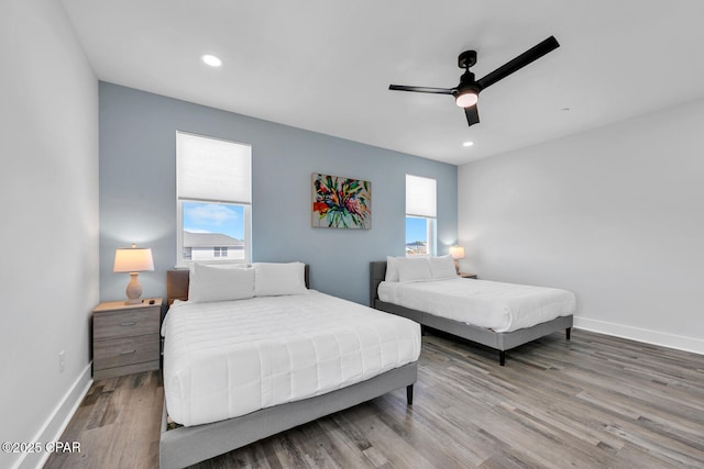 bedroom with a ceiling fan, recessed lighting, wood finished floors, and baseboards