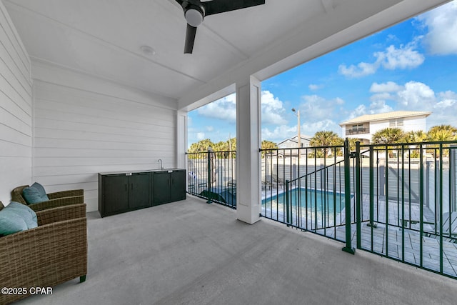 balcony featuring a patio area and ceiling fan