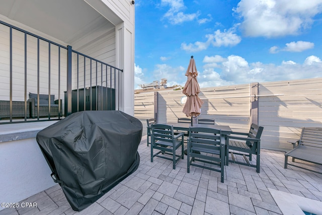 view of patio featuring outdoor dining area and a grill