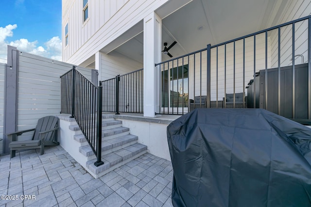 view of patio featuring a grill and fence