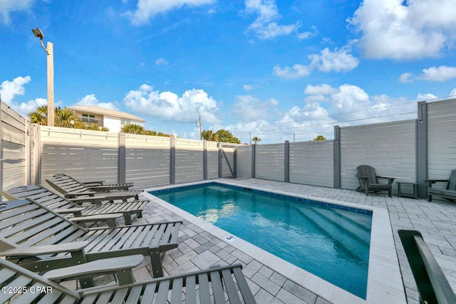 view of pool with a fenced in pool, a patio, and a fenced backyard