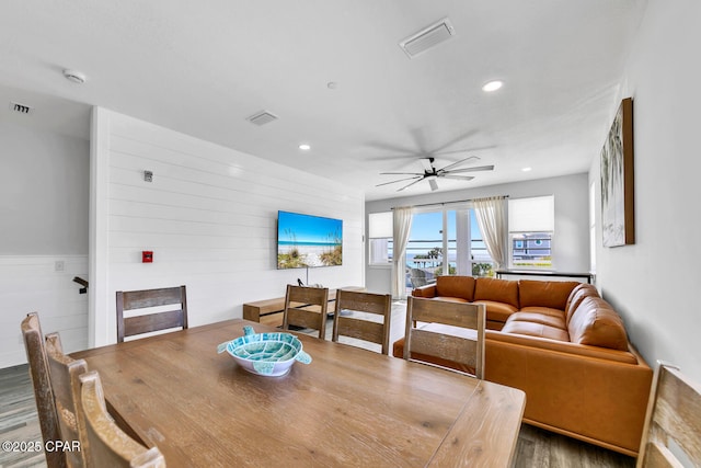 dining room featuring visible vents, a ceiling fan, and wood finished floors