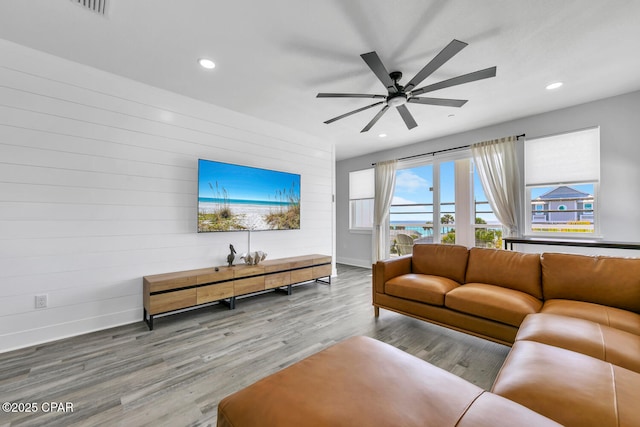 living area with recessed lighting, baseboards, wood finished floors, and a ceiling fan