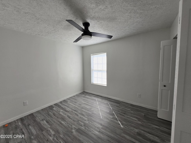 empty room with dark wood-type flooring, a textured ceiling, baseboards, and a ceiling fan