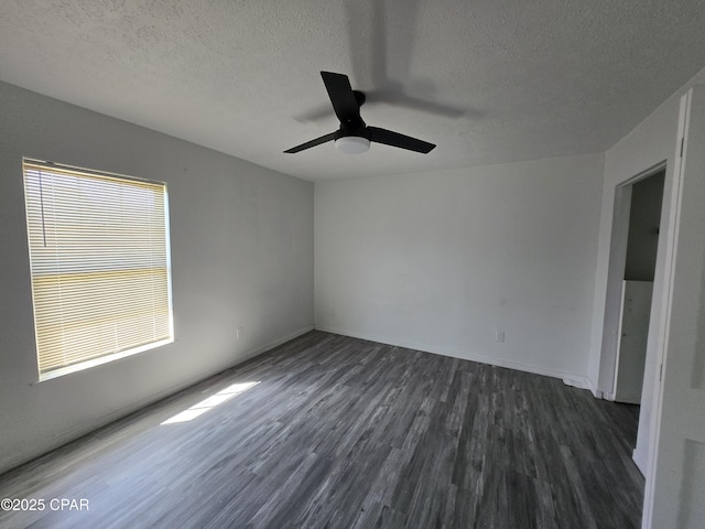 unfurnished room featuring dark wood-style floors, a textured ceiling, and a ceiling fan