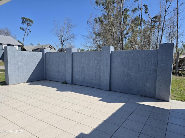 view of patio featuring fence