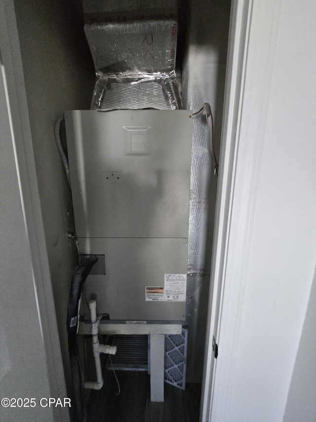 utility room featuring heating unit