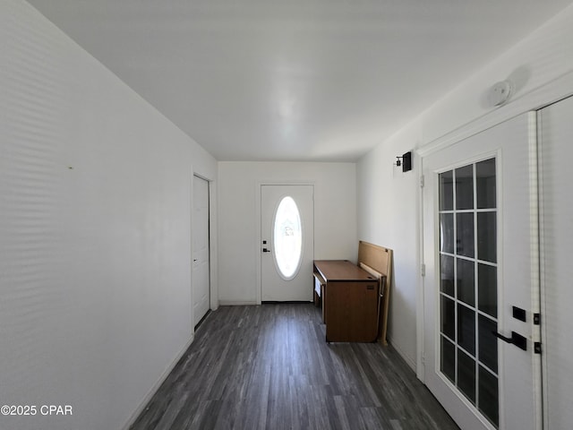 foyer entrance featuring dark wood-type flooring and baseboards
