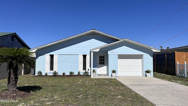 view of front facade with brick siding, an attached garage, driveway, and fence