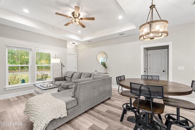 living area with baseboards and light wood finished floors