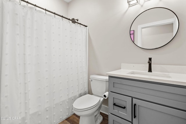 full bathroom with vanity, a shower with curtain, toilet, and wood finished floors