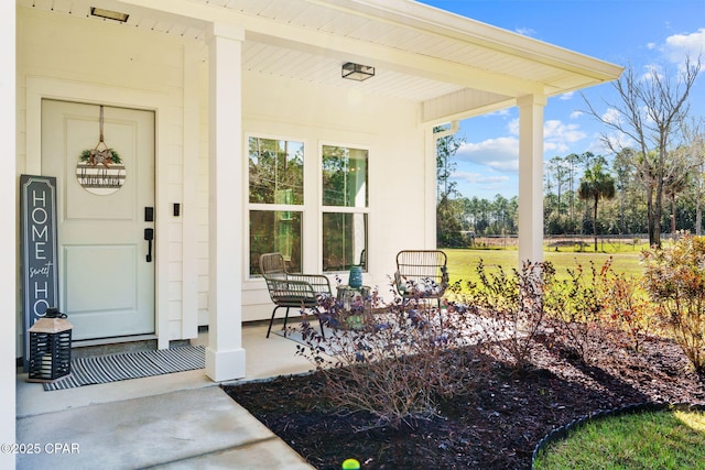 view of exterior entry with covered porch