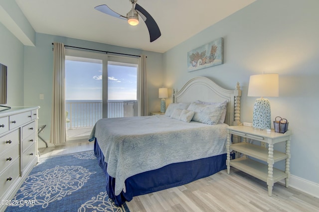 9860 S Thomas Dr Unit 1426, Panama City Beach, FL 32408 - bedroom with light wood finished floors, baseboards, access to exterior, and a ceiling fan