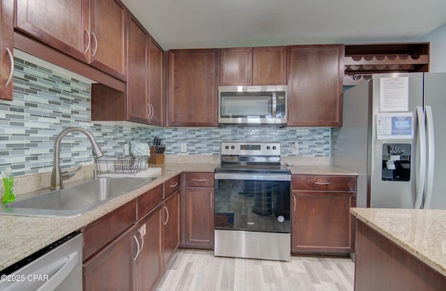 9860 S Thomas Dr Unit 1426, Panama City Beach, FL 32408 - kitchen with stainless steel appliances, a sink, light wood finished floors, and tasteful backsplash