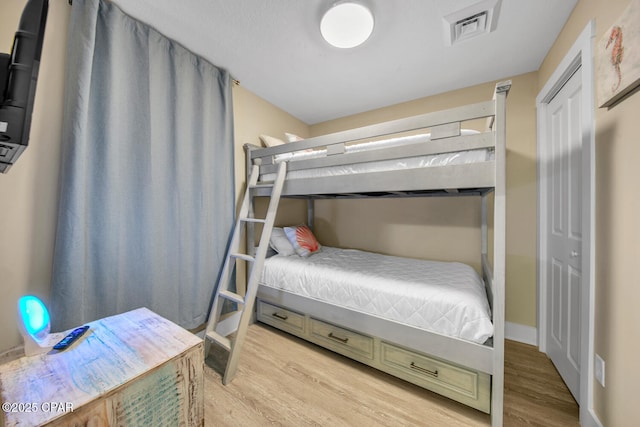 bedroom featuring visible vents and light wood finished floors