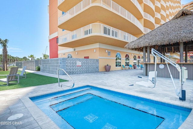 view of swimming pool featuring a patio area and fence