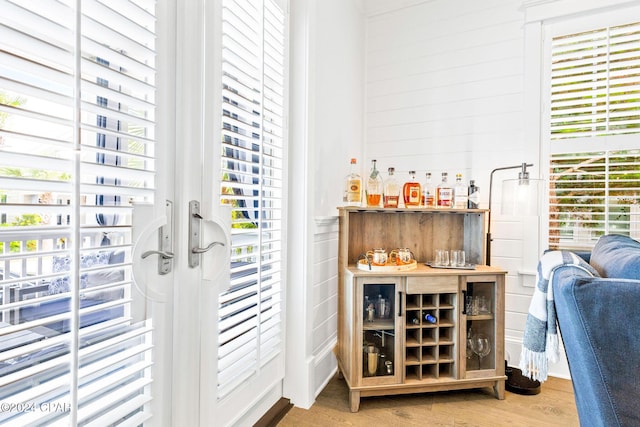 doorway featuring a bar and light wood-style flooring