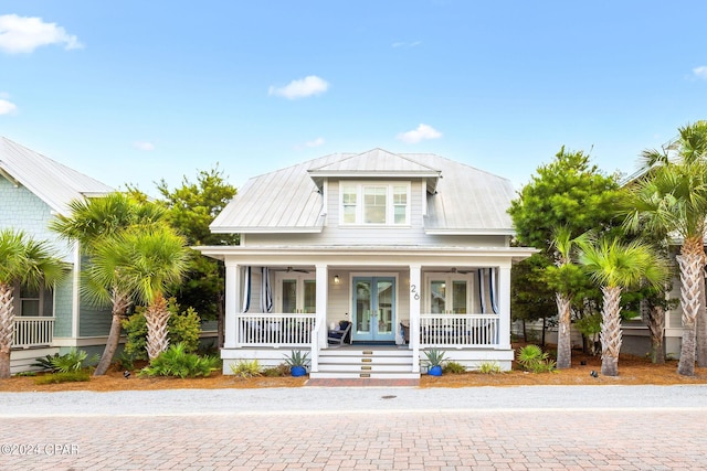 view of front of house with a ceiling fan, french doors, covered porch, and metal roof