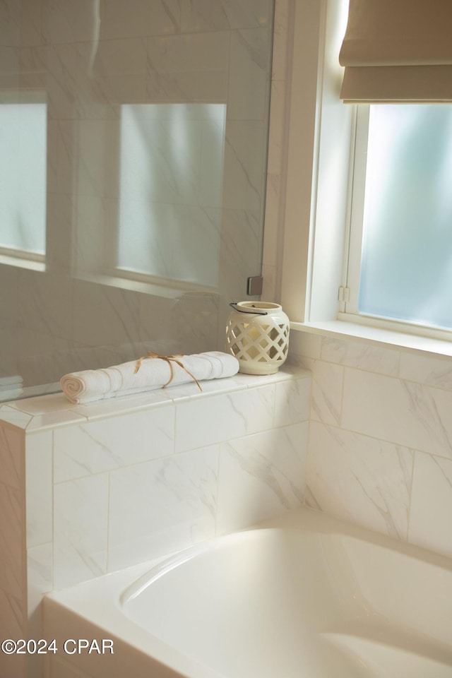 bathroom featuring a tub to relax in