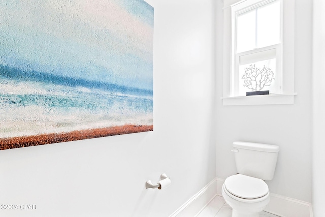 bathroom with toilet and baseboards