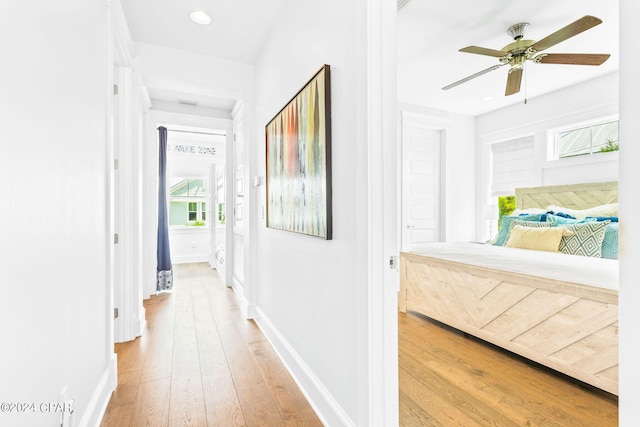 hall with recessed lighting, baseboards, and light wood-style flooring