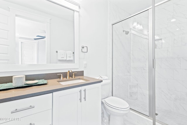 full bathroom featuring vanity, marble finish floor, a shower stall, and toilet