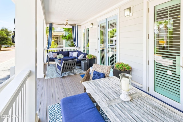 wooden terrace with an outdoor living space