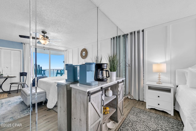 bedroom with wood finished floors and a textured ceiling