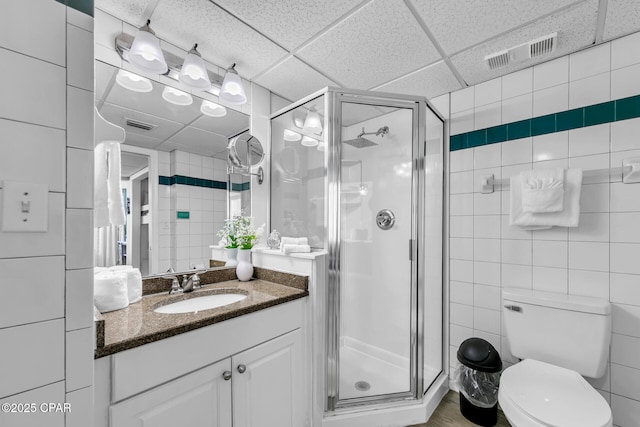 full bathroom featuring visible vents, tile walls, and a stall shower