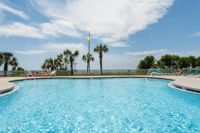 community pool featuring fence