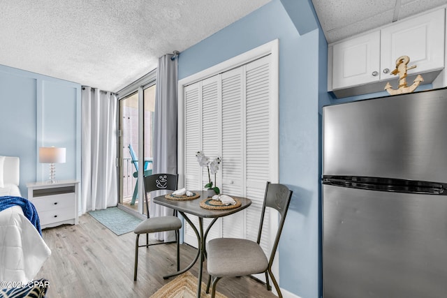 10509 Front Beach Rd Unit 1300E, Panama City Beach, FL 32407 - dining space with a textured ceiling and light wood-style floors