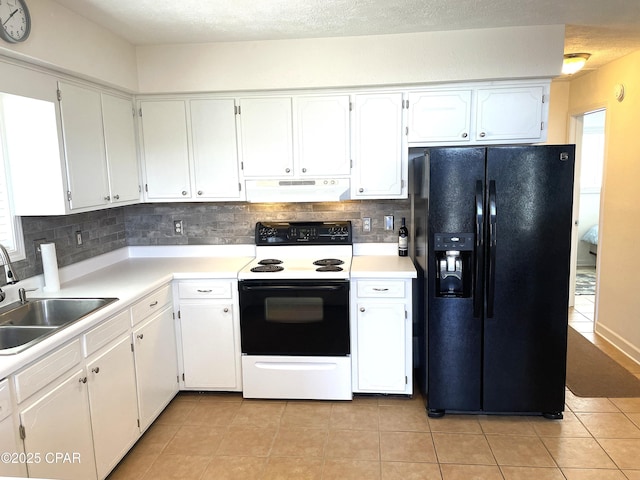 kitchen featuring range with electric cooktop, under cabinet range hood, a sink, backsplash, and black refrigerator with ice dispenser