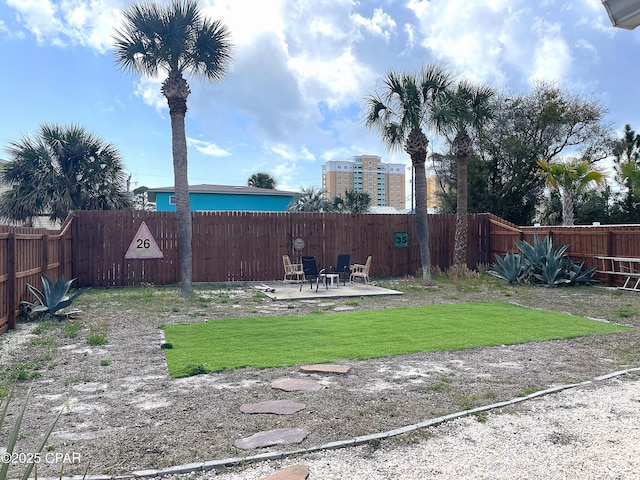 view of yard featuring a patio and a fenced backyard