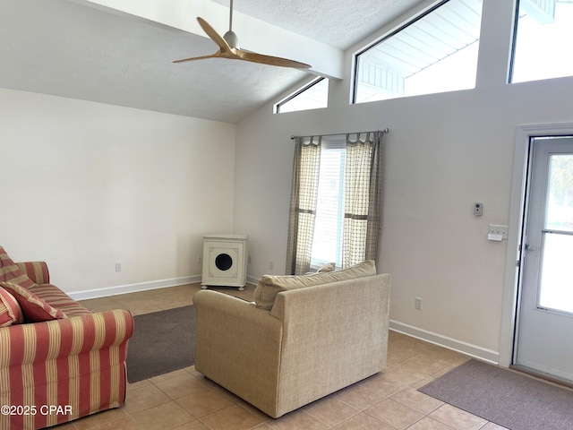 living room with vaulted ceiling with beams, a healthy amount of sunlight, and a textured ceiling