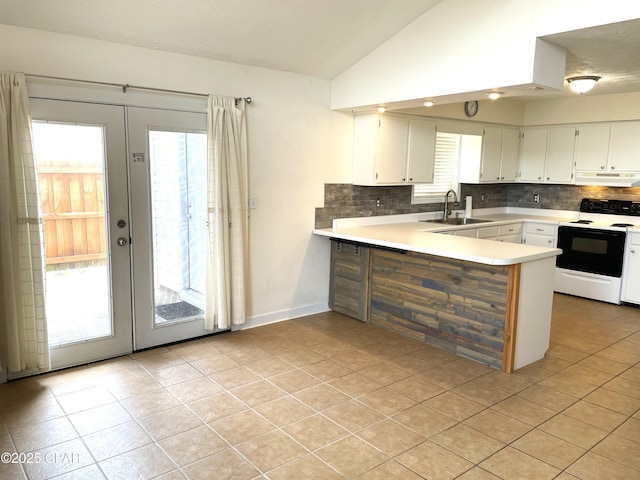 kitchen featuring vaulted ceiling, french doors, a peninsula, electric range, and a sink