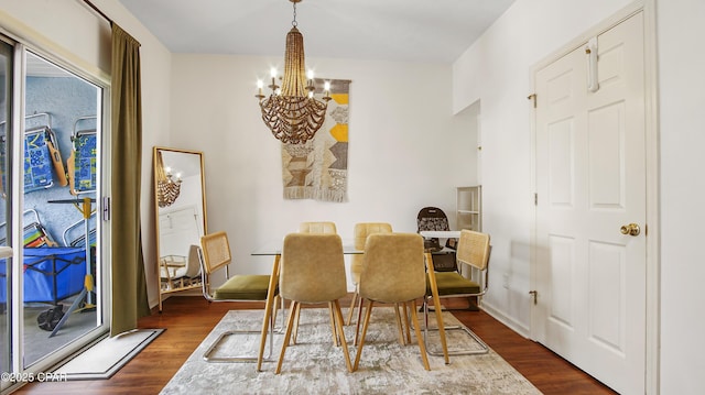 dining room featuring an inviting chandelier and dark wood finished floors